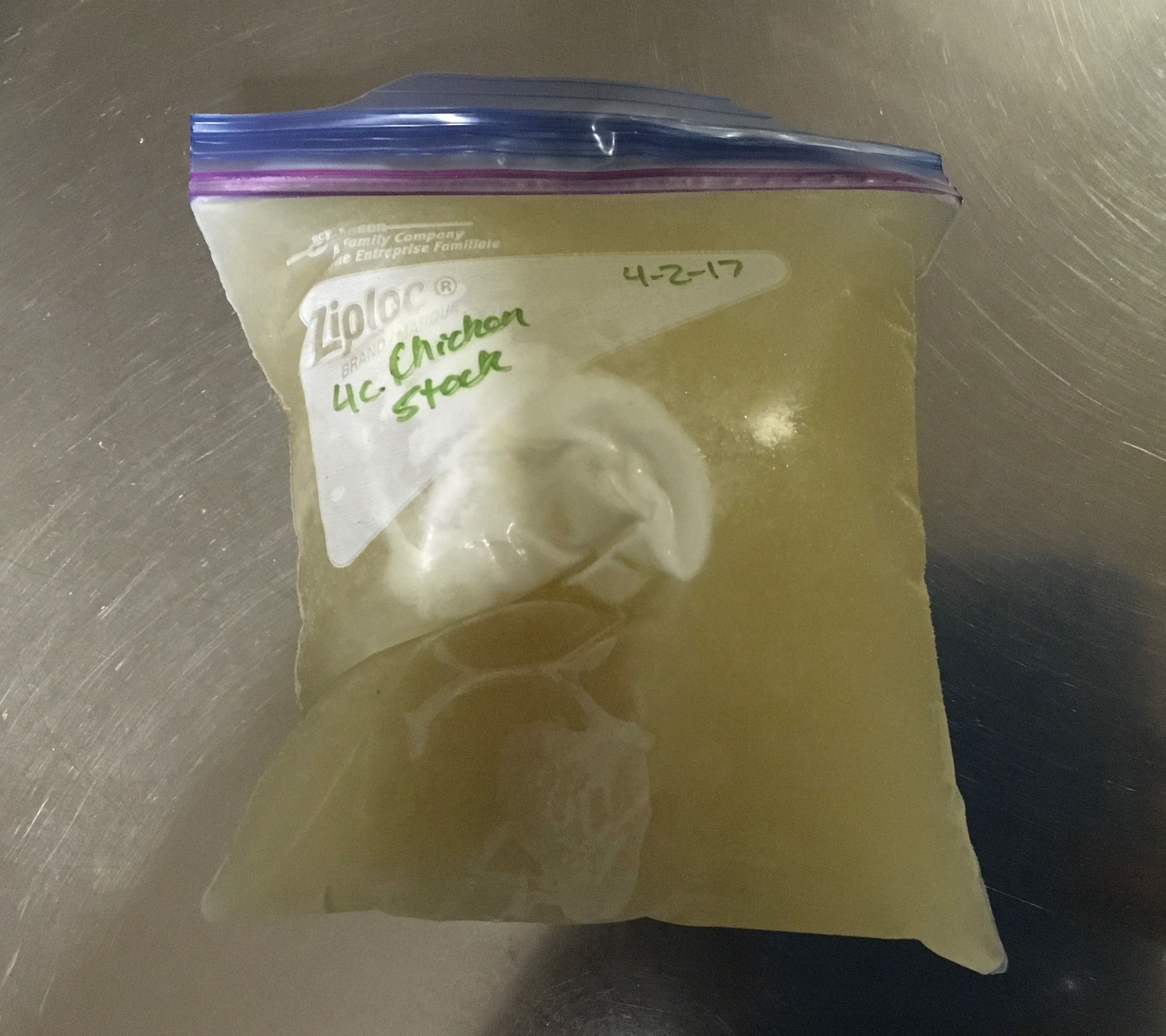 Frozen bag of homemade chicken stock.