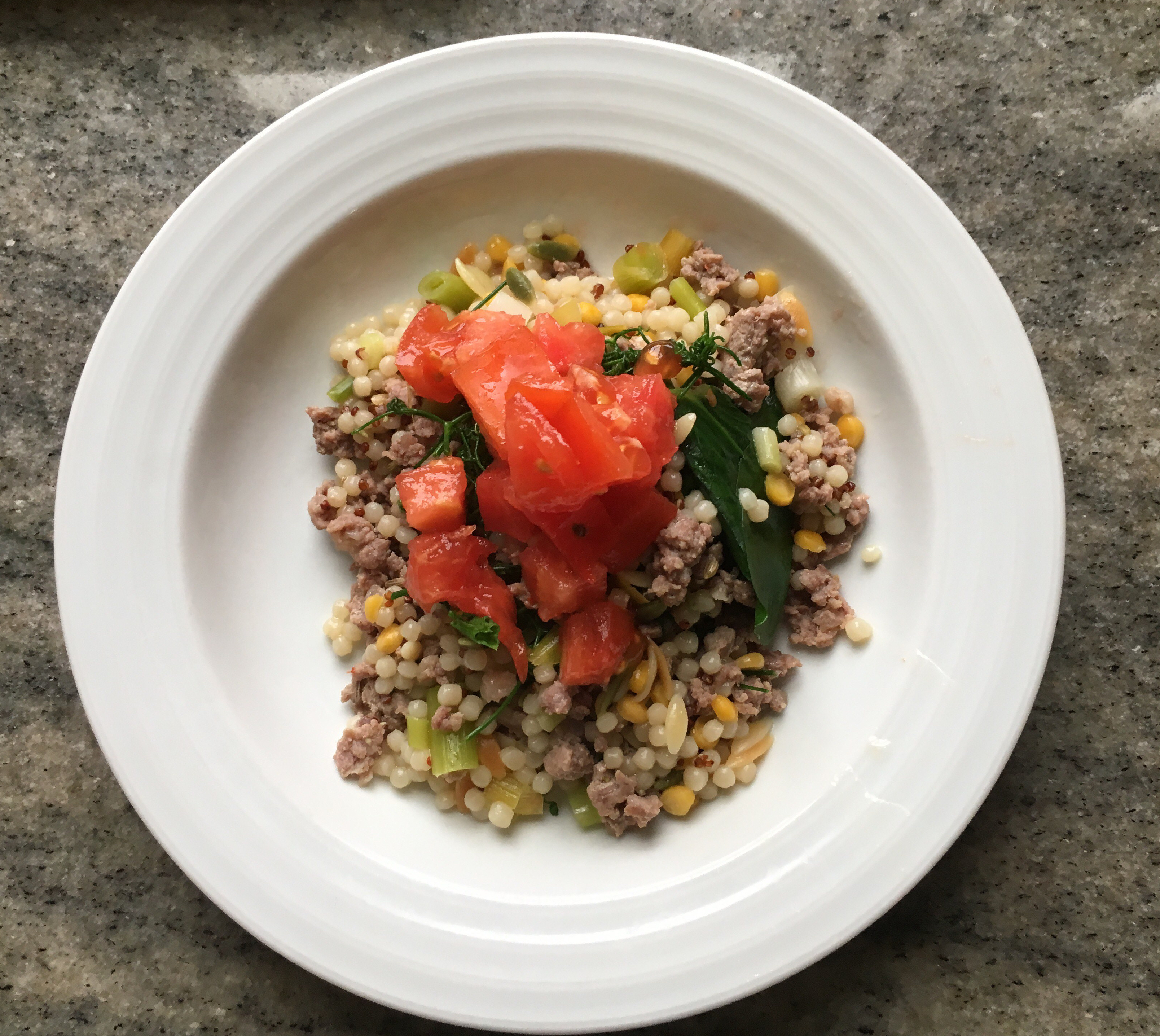 One-pan Cous Cous & Sausage with Pea Tendrils, Tomato & Green Garlic