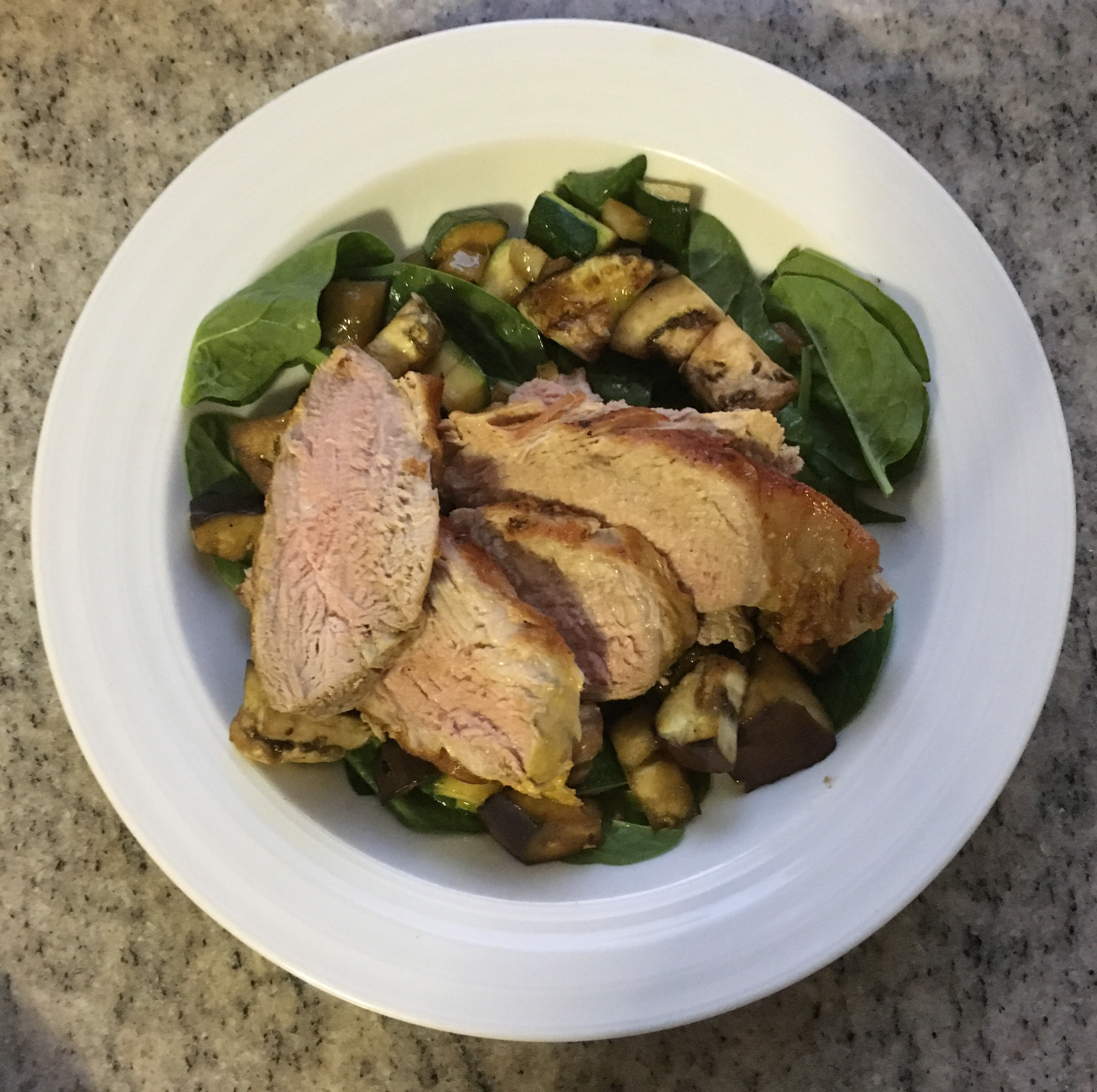 Pork tenderloin over warm eggplant, zucchini, fennel & spinach salad