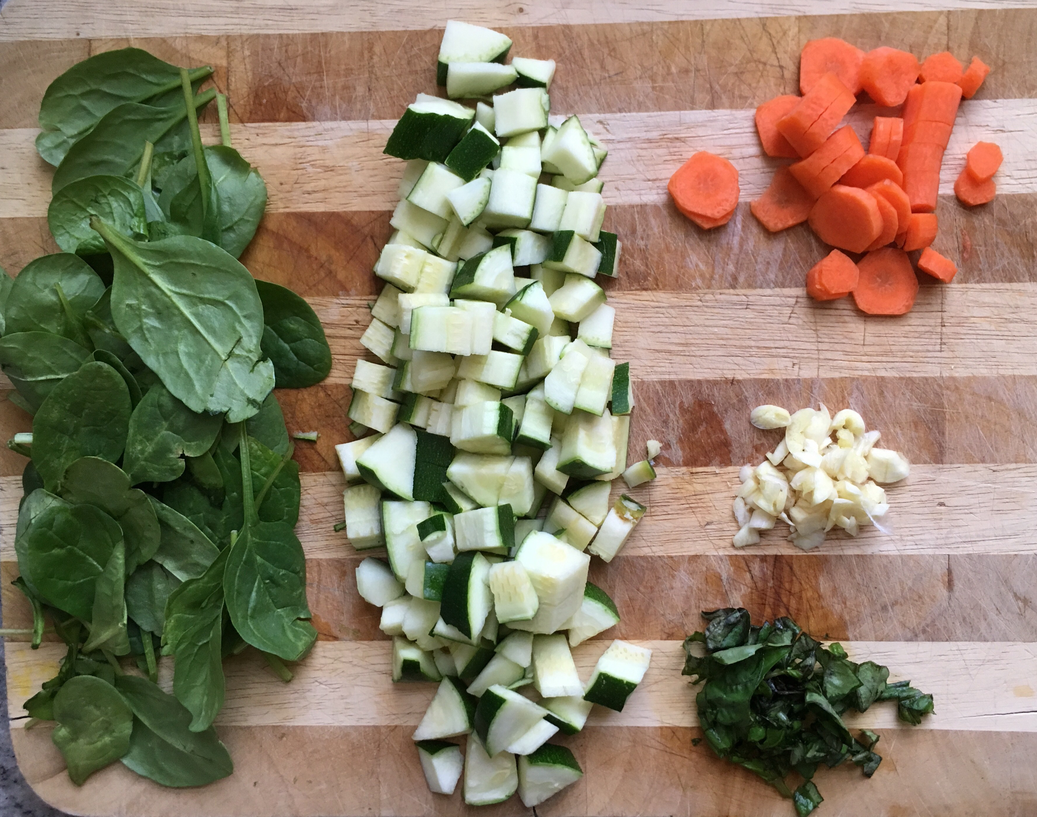 Chopping board with vegetables for the green diva pasta sauce