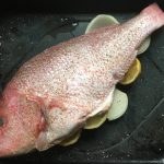 Picture of the prepared fish before roasting with onions, lemon, salt & pepper.