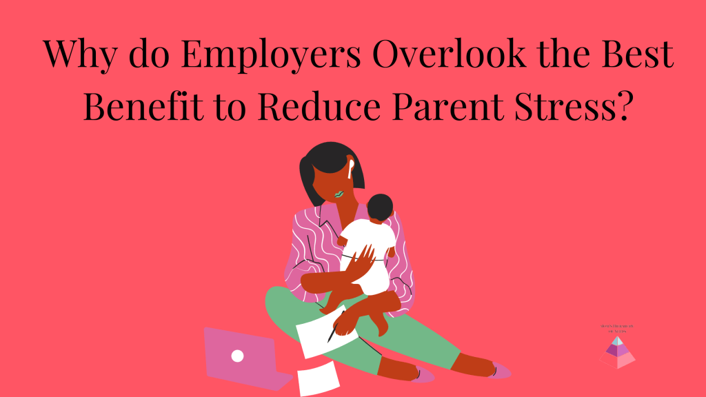 Mom sitting on the floor holding aa baby while trying to work on her laptop with papers and a notebook sliding off of her lap